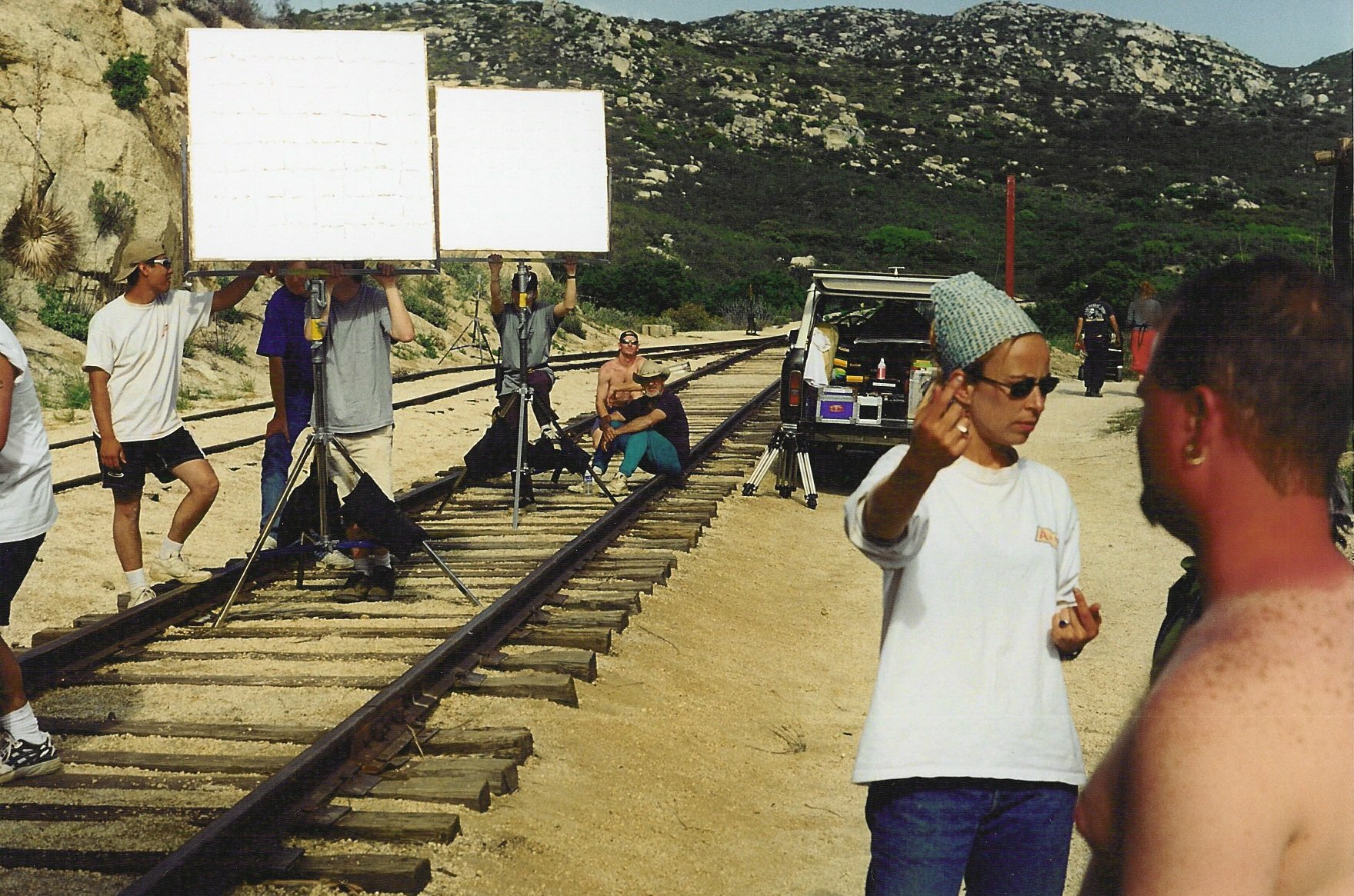 Aizea production crew setting lighting equipment along the tracks at Campo