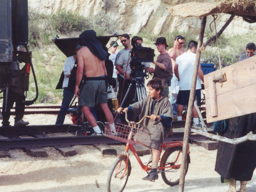 Aizea film crew and camera equipment beside railroad equipment at Campo