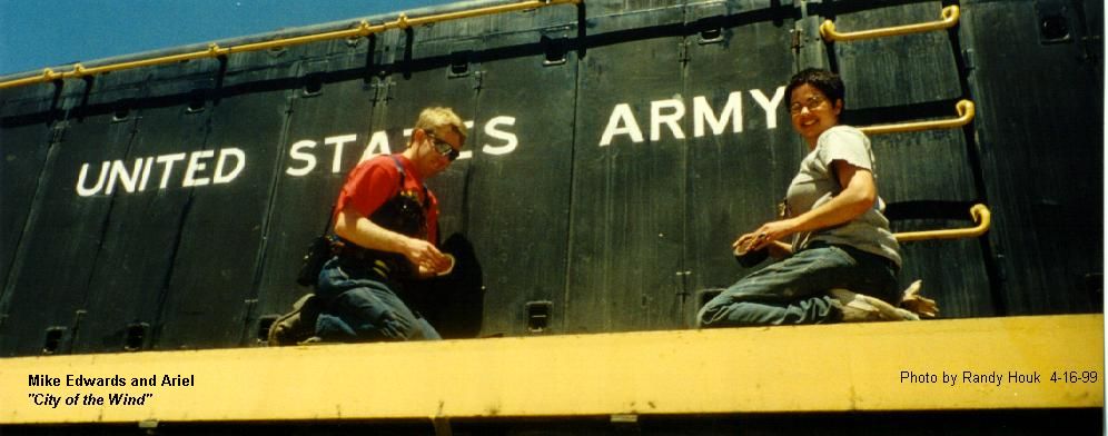 Actors seated on United States Army railroad equipment during Aizea filming